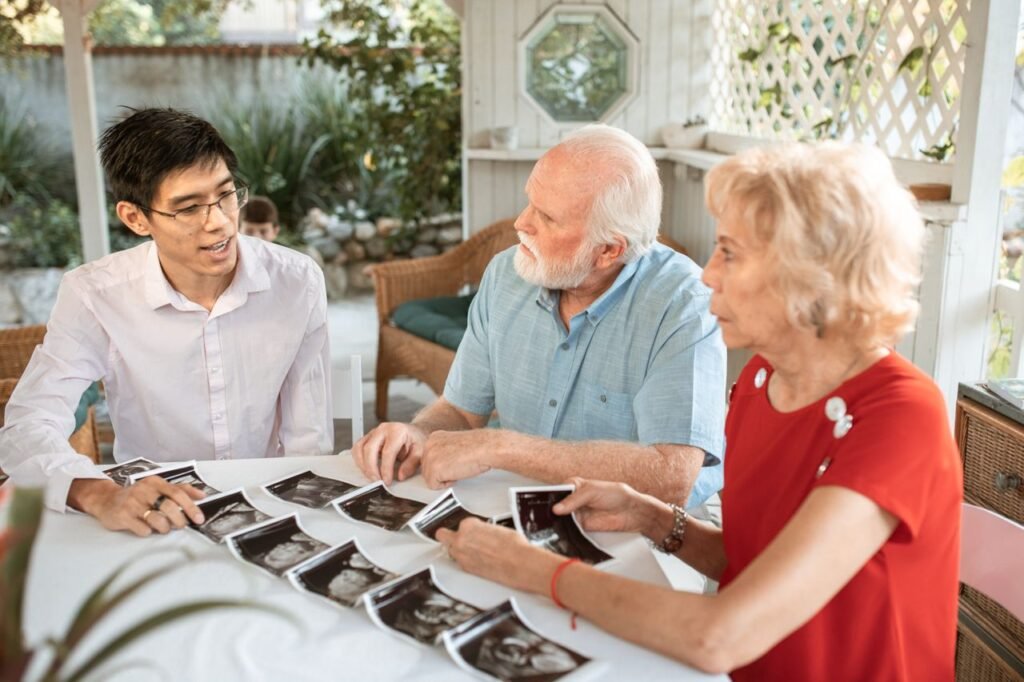 Family sits together discussing old images,